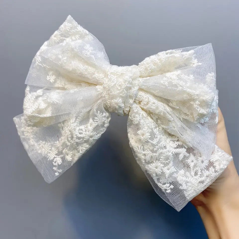 Oversized white lace bow